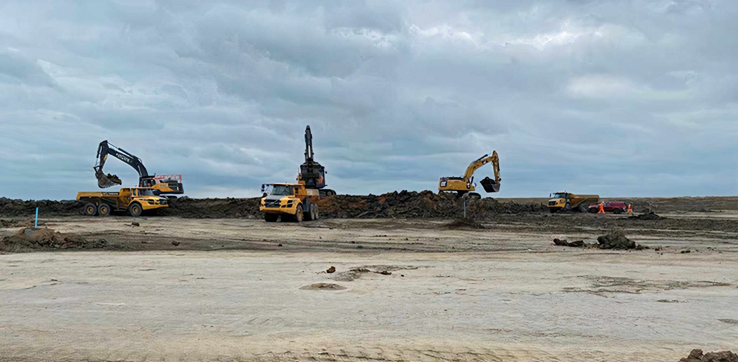 Large-scale bulk earthworks project in progress at Priors Hall, with multiple excavators loading soil into articulated dump trucks on a major construction site.