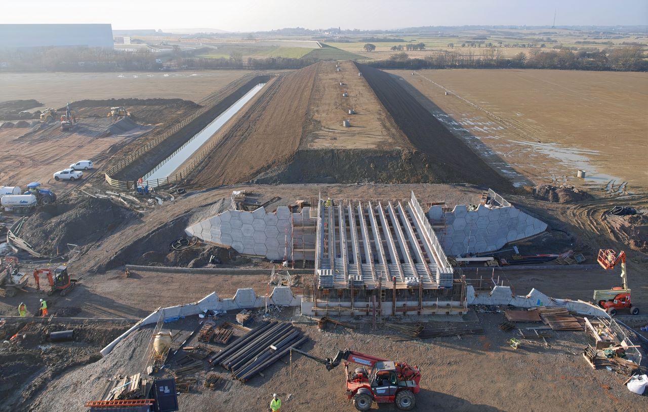 County Civils managing a major UK infrastructure project, showing construction of a reinforced concrete bridge and large-scale drainage earthworks.