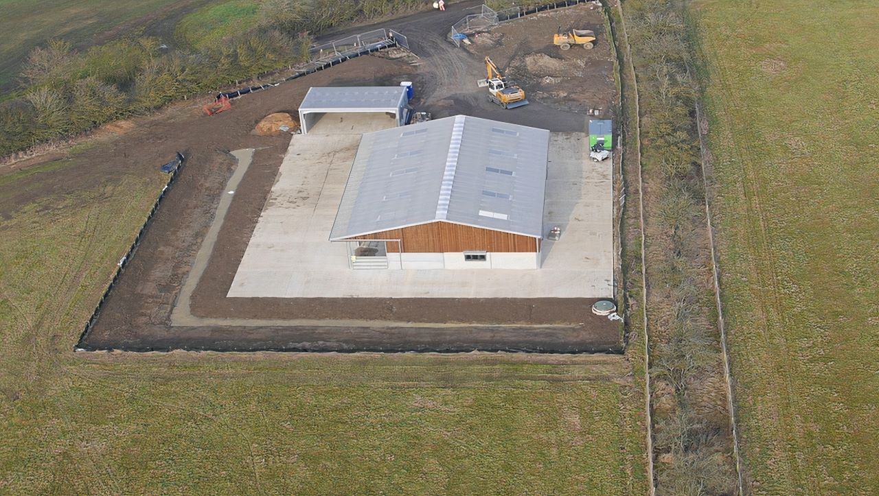County Civils' complete groundworks package for a new UK agricultural facility, showing the large concrete foundation slab, drainage, and site access.
