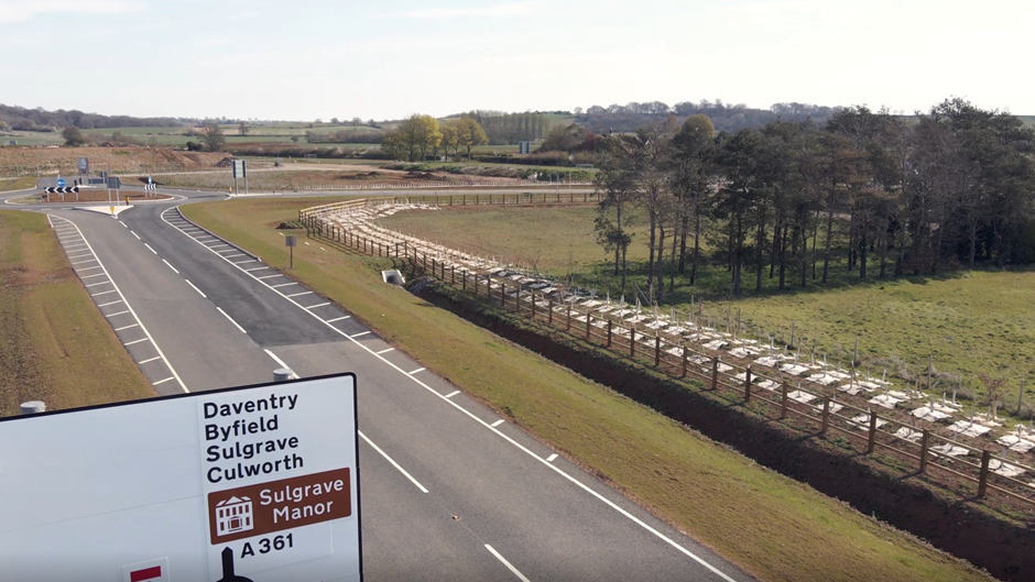 Newly constructed A361 road and roundabout, part of a civil engineering highway project in Northamptonshire, with a road sign for Daventry and Sulgrave Manor.